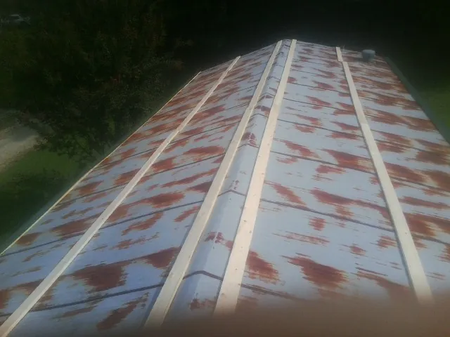 Rusted metal roof panels with new wood purlins before replacement — Storm Damage Roof Repair in West Newfield by Roofing Brothers