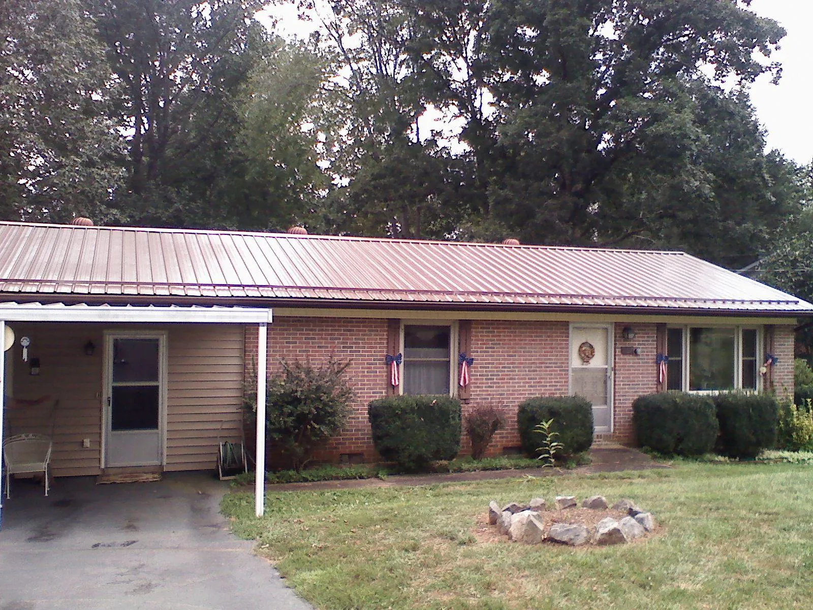 Bronze metal roof and carport on a brick ranch home — Roof Repair work by our crew in West Newfield