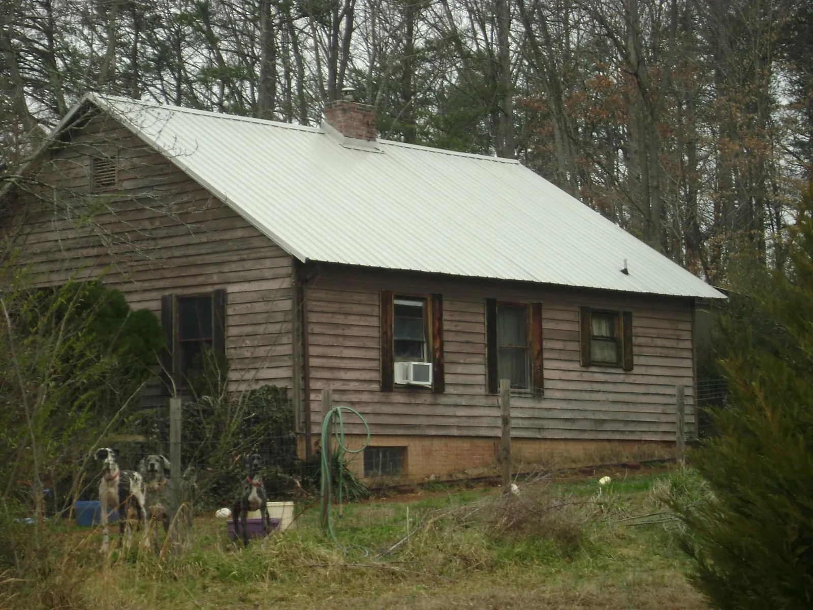 White metal roof on an old wood sided farmhouse, from a Metal Roof Installation job in West Newfield