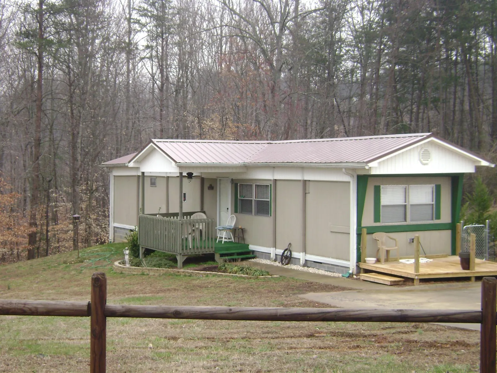Mauve metal roof on a manufactured home with a new front deck in West Newfield